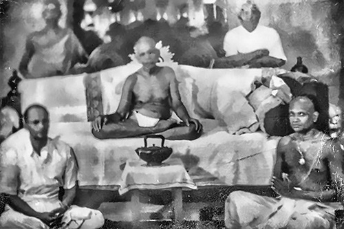 Bhagavan Sri Ramana Maharshi seated in the hall in 1949 with Chinnaswami, Chavali Sastri, K.K. Nambiar and Vaidyanatha Sthapati, builders of the Matrubhutesvara Temple